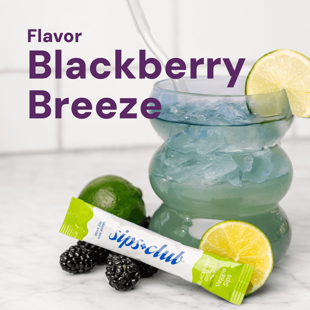 Veggie Sips Flavor - Blackberry Breeze Flavor Rip Pack in  front of fresh blackberries and limes and a glass cup with ice and the drink