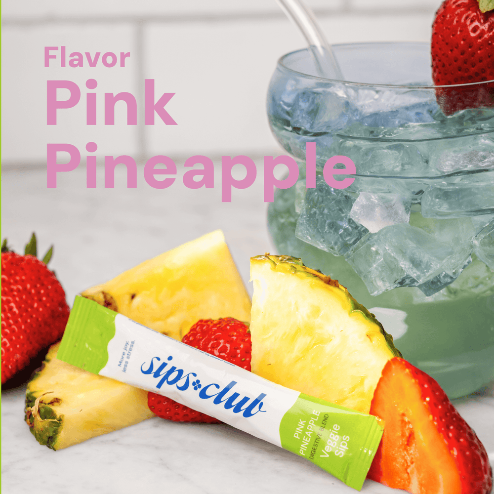 Veggie Sips Flavor - Pink Pineapple Flavor Rip Pack in  front of fresh pineapple and strawberries and a glass cup with ice and the drink